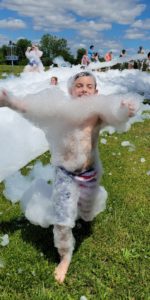 child covered in foam at foam party